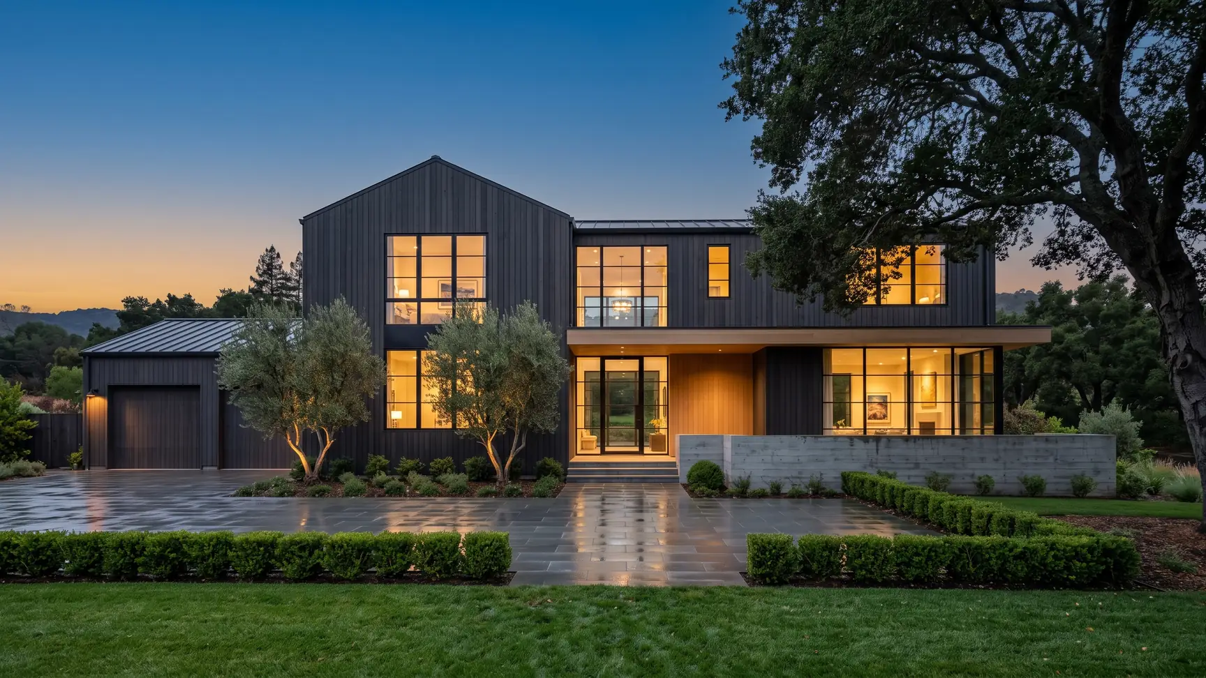 Completed Shape home at dusk with warm glowing windows